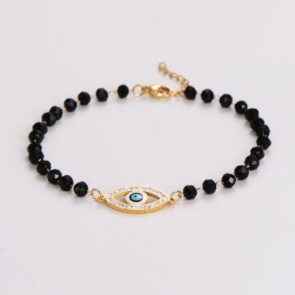 Pulsera ojo turco con borlas negras chapada en oro de 18k