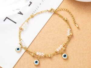 Pulsera doble cadena con dijes de ojos turcos colgantes y borlas blancas de acero inoxidable