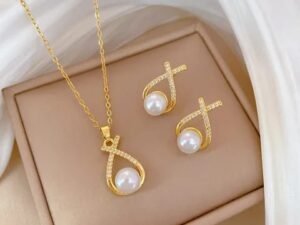 Set dorado perla colgante X con circonia de acero titanio chapado en oro