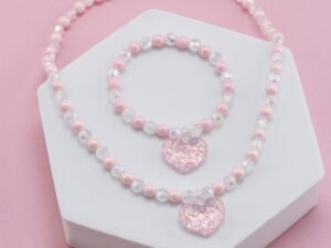 Set rosado infantil corazón y borlas de resina