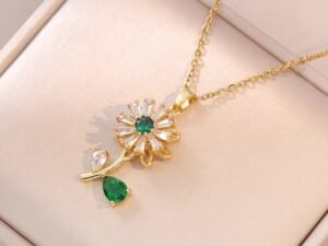 Collar dorado girasol giratorio circonias verdes acero titanio